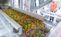 Mars uses artificial to sort Skittles colors, ensuring an array of colors in each pack. Photograph shows Skittles coming down the production line. 